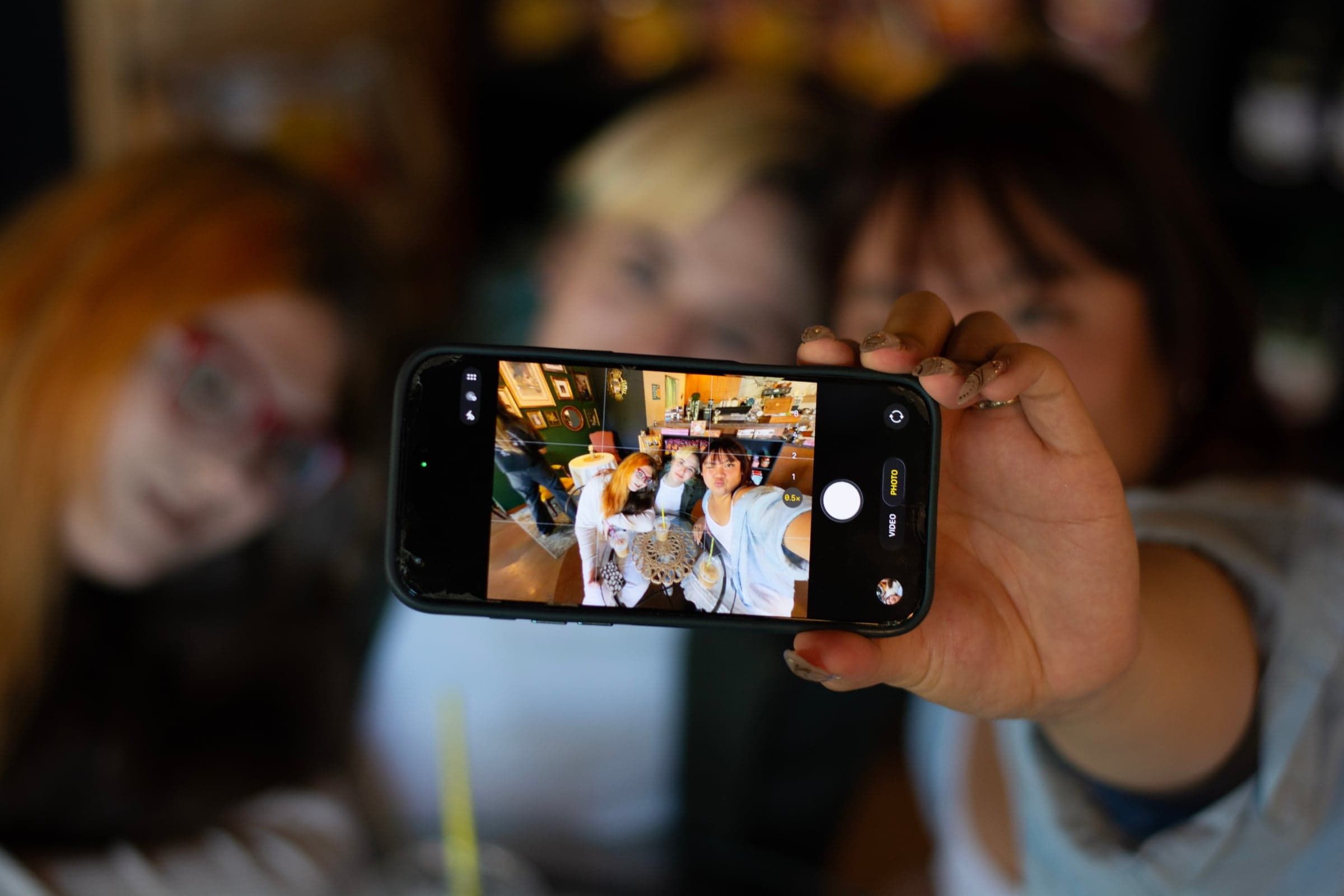 Friends taking a selfie together in a café